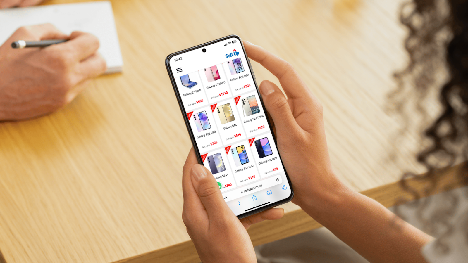 Person browsing smartphone resale listings on a mobile website